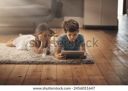 Kids, video and playing with technology on floor for digital education, ebook and learning in house. Boy, girl and tablet on ground for cartoon, children story and movie or virtual gaming app in home