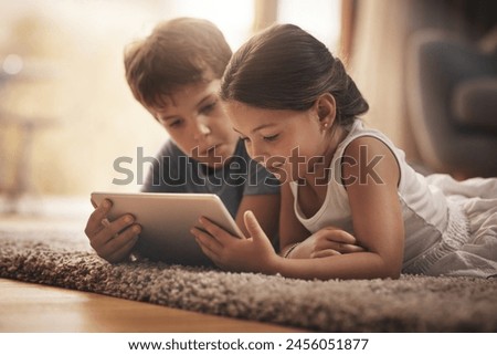 Children, movie and watching with tablet on floor for digital education, ebook and learning in house. Boy, girl and tech on ground for cartoon, kids story and video or virtual gaming app in home