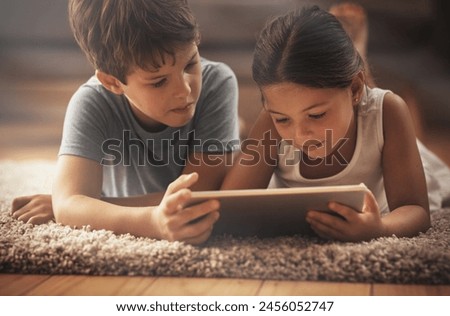 Kids, video and playing with tablet on floor for digital education, ebook and learning in house. Boy, girl and tech on ground for cartoon, children story and movie or virtual gaming app in home