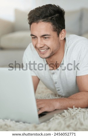 Man, laptop and student for study in home, floor and browse for research on college project. Male person, lounge and university website for e learning, education and app for knowledge or online class