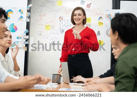 Professional attractive female leader presents creative marketing plan by using brainstorming mind mapping statistic graph and colorful sticky note at modern business meeting room. Immaculate. Royalty-Free Stock Photo #2456066221