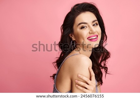 Beautiful woman in a dress striking a pose against a vibrant backdrop.