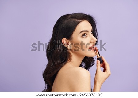 A woman gracefully holds a lipstick in her hand, enhancing her natural beauty.