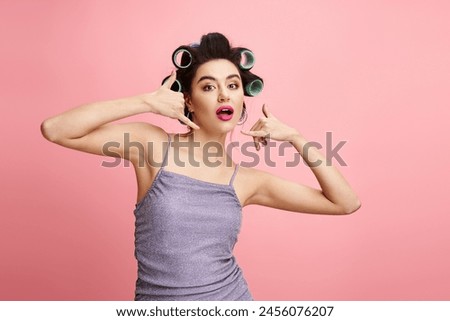 A woman with curlers in her hair, enhancing her natural beauty with makeup.