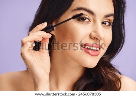 Woman enhancing natural beauty with mascara application.