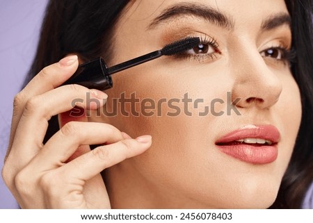 A woman with natural beauty delicately applying mascara to enhance her features.