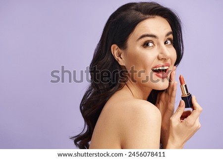 A woman holds a lipstick, enhancing her natural beauty with a touch of color.