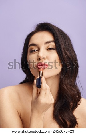 A woman holding a lipstick in front of her face, enhancing her natural beauty with makeup.