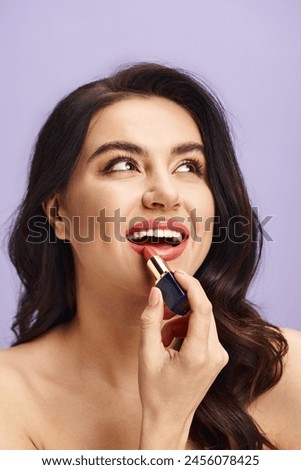 A beautiful woman enhancing her natural beauty by applying lipstick to her lips.