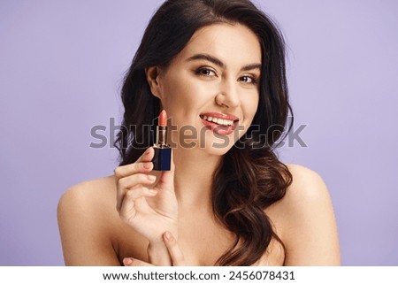 A woman gracefully holds a lipstick, enhancing her natural beauty.