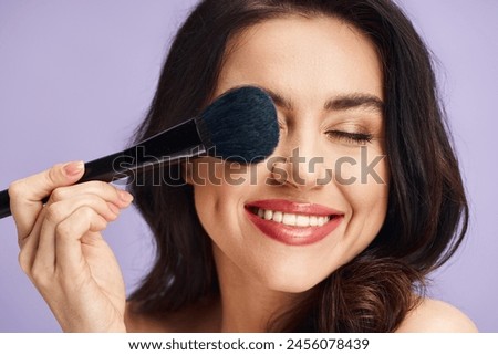 A woman enhancing her natural beauty with makeup application.