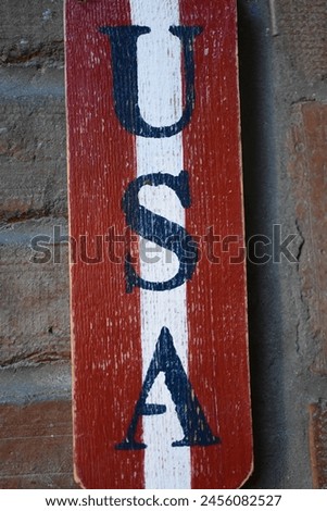 USA text on wooden board with brick background