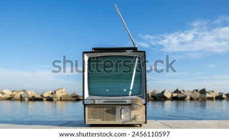 retro television with glitch next to the sea
