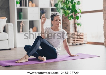 Full size photo of nice retired woman stretching exercises sportswear sport healthy lifestyle workout modern apartment home living room