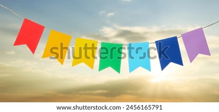 Garland with colorful flags outdoors. Banner for Cinco de Mayo celebration