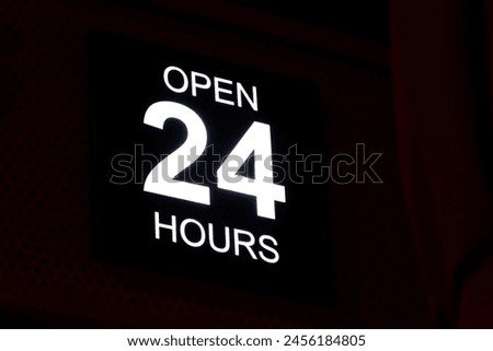 Open 24 Hour neon sign in the street.