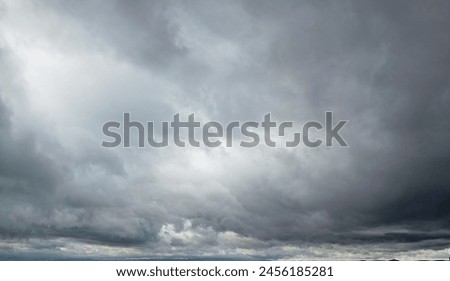 Hurricane Idalia warning sign against a powerful stormy background with copy space. Dirty and angled sign with cyclonic winds add to the drama.hurricane season sign on cloudy background Royalty-Free Stock Photo #2456185281