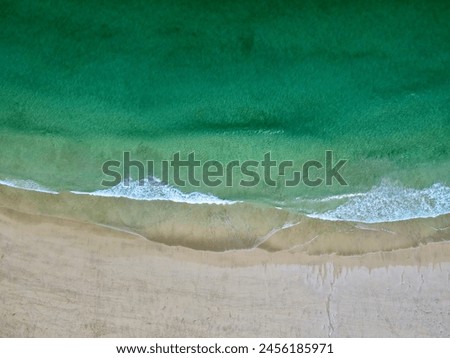 aerial shot of waves on beach