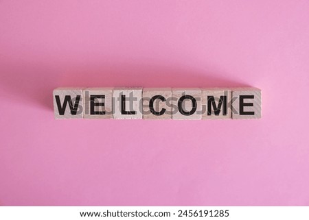 Word WELCOME written on wooden cubes.Wood abc. Holidays and education concept.