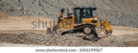 Construction work in the mountains, the tractor is working. stock photo