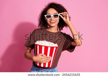 Photo of cheerful positive girl wear brown trendy clothes hold popcorn eyewear isolated on pink color background