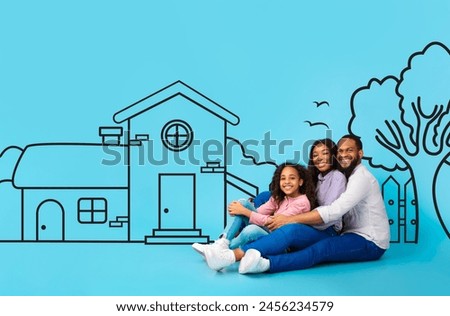 A cheerful African American family, consisting of a father, mother, and young daughter, sits closely snuggled and embracing. Behind them, a simplistic illustration of a house on blue background