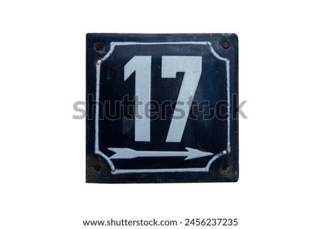 Weathered metal plate of number of street address number 17 isolated on white background