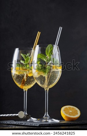 Refreshing Hugo Spritz Cocktail with Elderflower Liqueur, Mint and Lemon on Dark Background