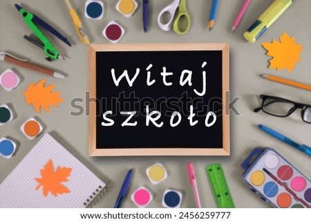 Back to School text in Polish. Blackboard with inscription against background of school supplies.  Top view on flat lay. Concept of new school year at school in Poland, Learning Polish language Royalty-Free Stock Photo #2456259777