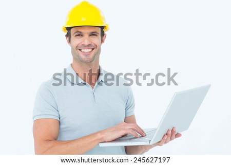 Portrait of happy carpenter using laptop over white background