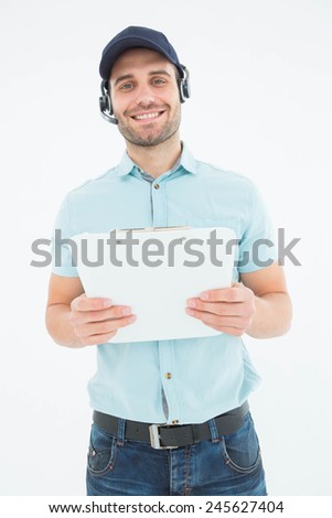 Portrait of happy male courier man wearing headset while holding clipboard on white background