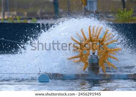 Paddlewheel (Fan) in industrial shrimp pond in Vietnam Royalty-Free Stock Photo #2456291945