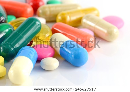 Colorful of oral medications on White Background. Royalty-Free Stock Photo #245629519