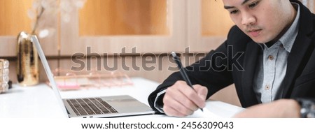 confident businessman wearing glasses signing contract at group negotiations, business partners making successful investment deal, agreement, salesman putting signature on legal documents