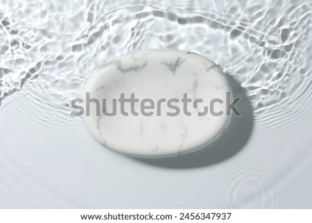 Presentation for product. Marble podium in water on white background, top view
