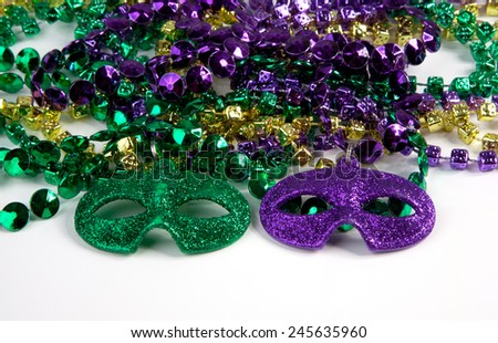 Mardi Gras beads with masks on a white background.