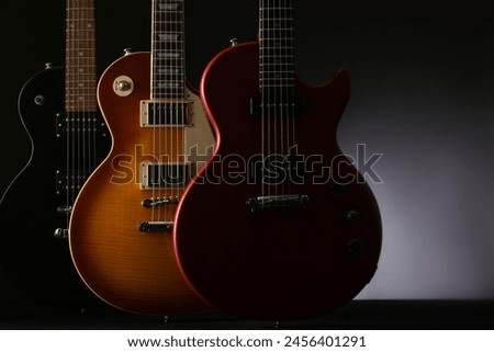 Outline of an electric guitar on a black background
