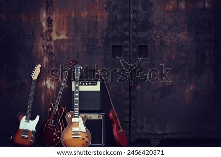 Group photo of electric guitars taken in an outdoor garage