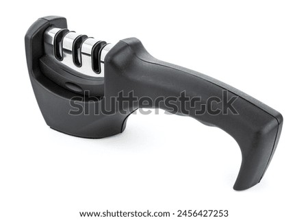 knife with sharpener on the table. Knife and knife sharpener on a white surface. Kitchen tools isolated on white background. Reversible manual knife sharpener.	 Royalty-Free Stock Photo #2456427253