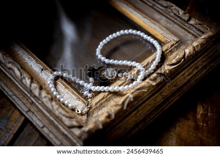 Antique picture frames and pearl accessories.