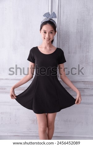  Portrait beauty woman in black dress on wooden door background 