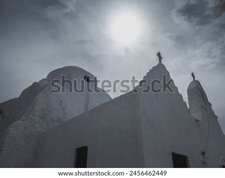 Black and white photo. The silhouette of an old white washed Greek othodox church in Mykonos, Cyclades Islands, Aegean Sea, Greece