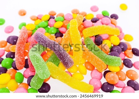 Bright multi-colored candies with gelatin worms