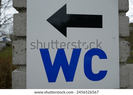 Water closet direction sign for public restroom