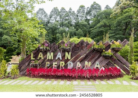 Laman Perdana beautiful red pink purple flowers and sign Perdana Botanical Gardens Lake Gardens in Kuala Lumpur, Malaysia.