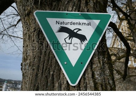 Naturdenkmal German language sign for natural monument posted on tree