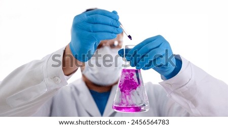 A male chemist holds test tube of glass in his hand overflows a liquid solution of potassium permanganate conducts an analysis of water samples versions of reagents using chemical manufacturing. Royalty-Free Stock Photo #2456564783