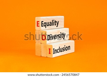 EDI equality diversity inclusion symbol. Concept words EDI equality diversity inclusion on blocks. Beautiful orange background. Business EDI equality diversity inclusion concept. Copy space.