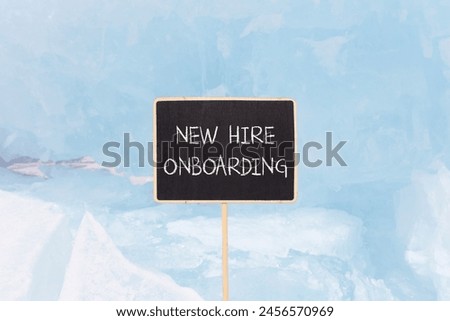 New hire onboarding symbol. Concept words New hire onboarding on beautiful yellow black blackboard. Beautiful blue ice background. Business new hire onboarding concept. Copy space.