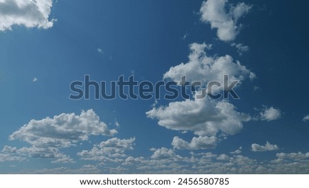 Large dark cumulus cloud in blue sky. Epic dramatic storm dark grey and white cumulus rain clouds. Timelapse.